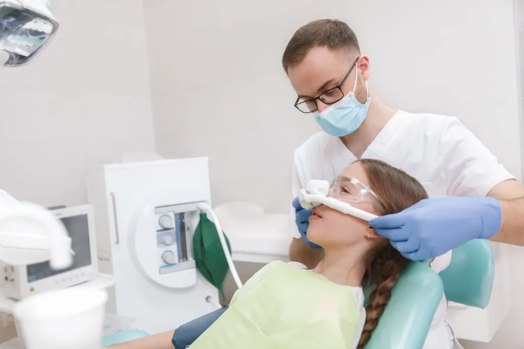 oral surgeon putting laughing gas to a patient